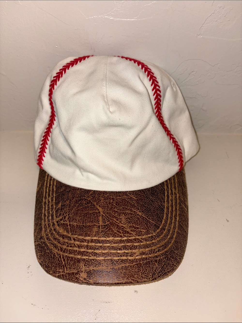 White and Red Baseball-Style Cap with Brown Brim